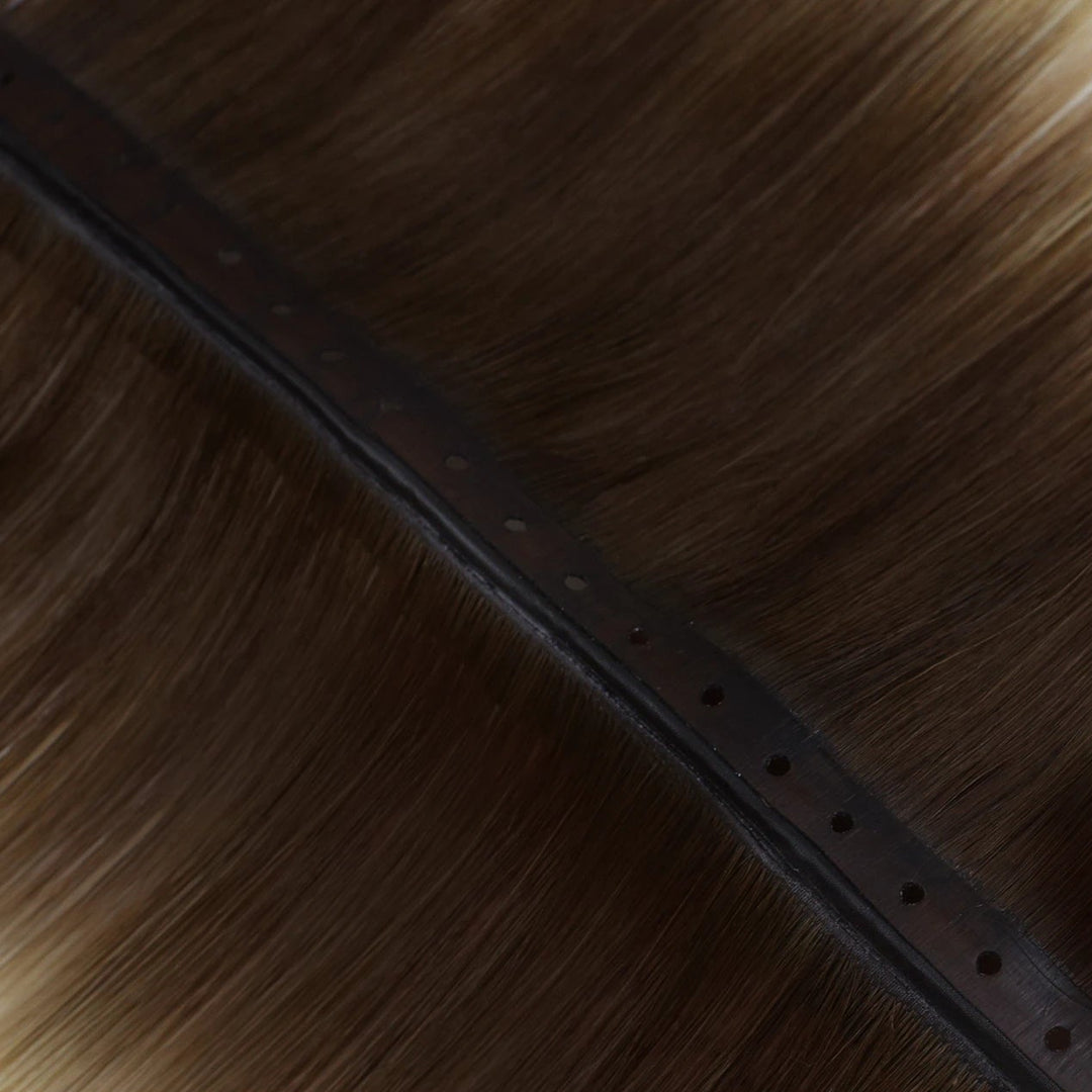 Deep brown balayage butterfly wefts enhanced with subtle blonde highlights for a sophisticated look.