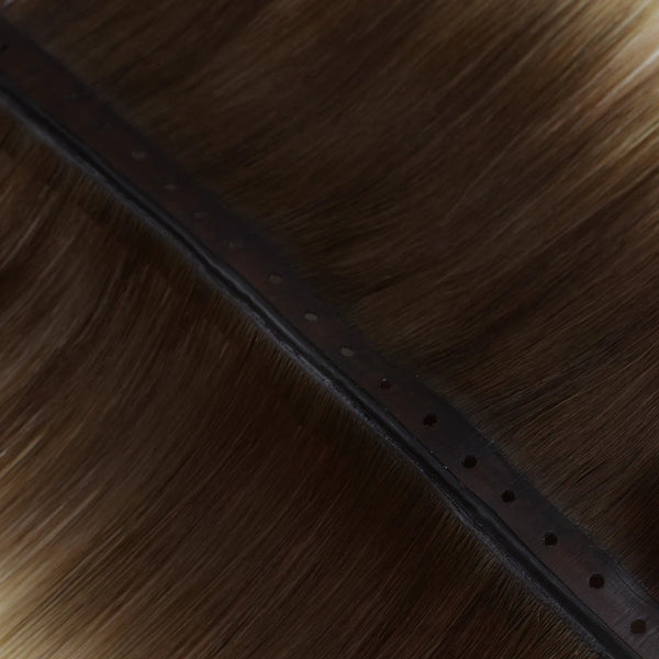 Deep brown balayage butterfly wefts enhanced with subtle blonde highlights for a sophisticated look.