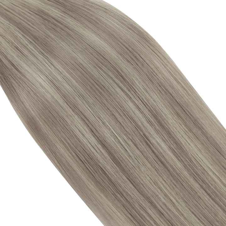 Soft blonde butterfly weft hair extensions paired with lush highlights for a radiant effect.