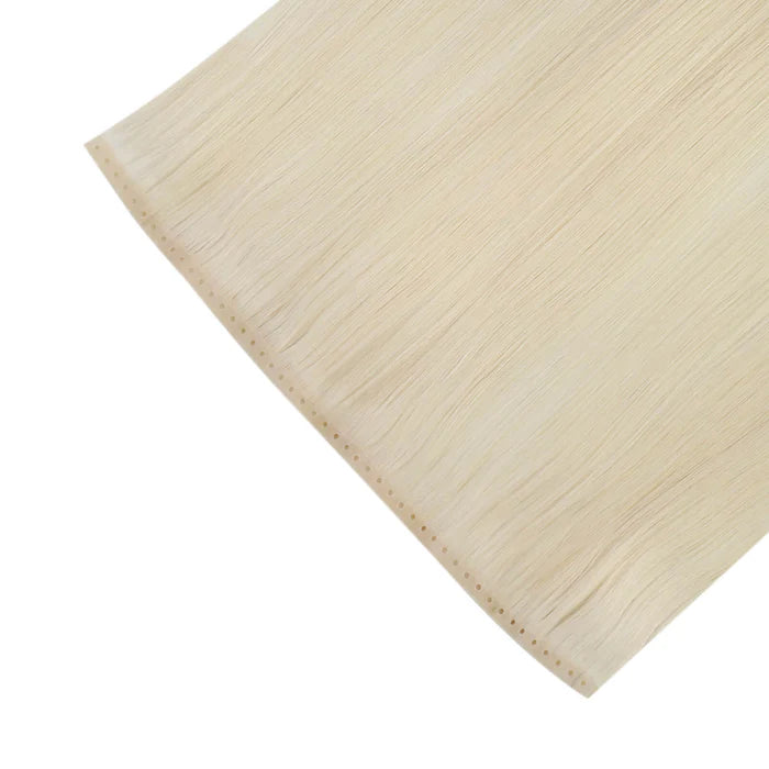 Close-up of stylist attaching butterfly weft extensions with microbeads in salon.